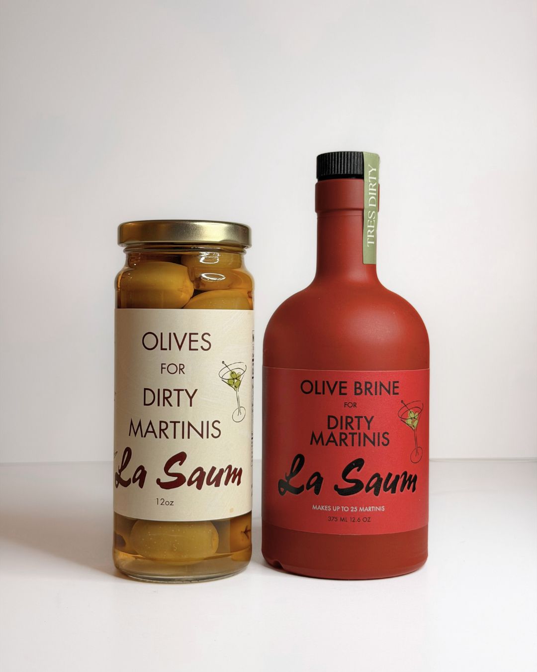 Two bottles of La Saum olive products on a white background