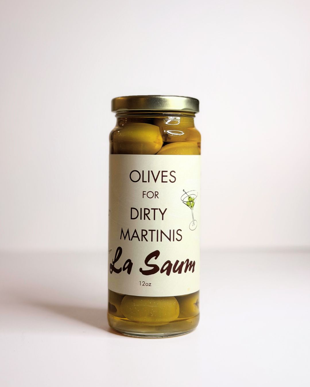 Jar of olives labeled 'Olives for Dirty Martinis La Saum' on a white background